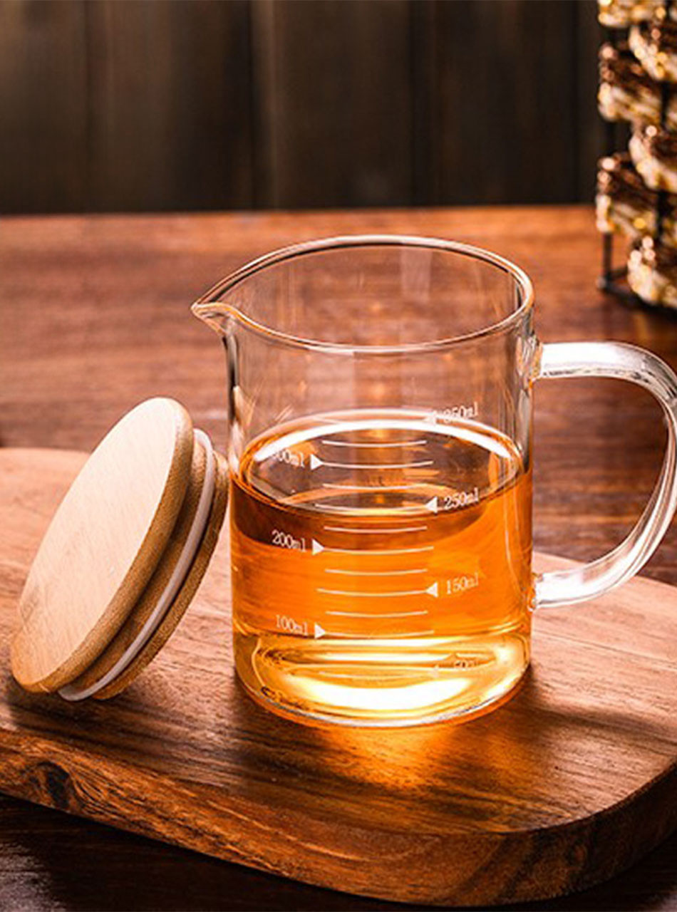Glass Measuring Cup with handle, poised for precision in adventurous play.