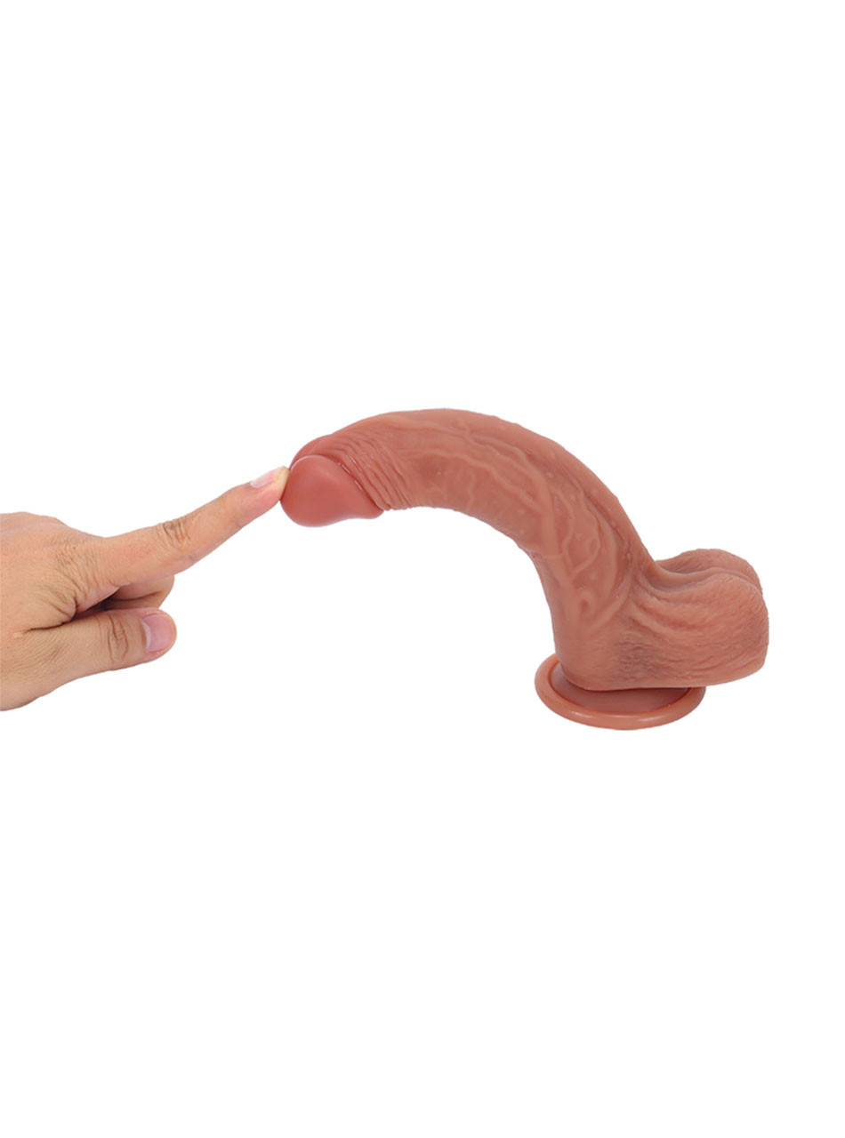 Flexible realistic dildo bent to demonstrate softness and elasticity.