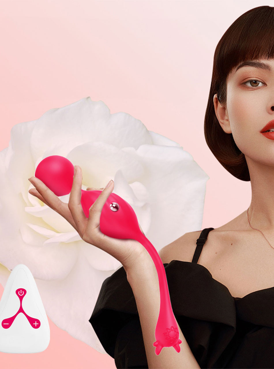 Woman holding pink kegel toy with remote, elegant floral backdrop