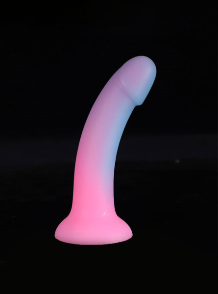 Glow-in-the-dark pastel dildos lighting up in dark setting