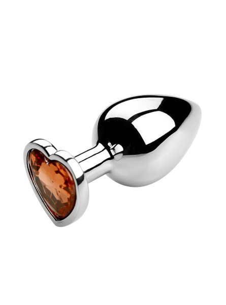 Yellow heart jewel metal butt plug on a reflective surface, ideal for enhancing anal play.