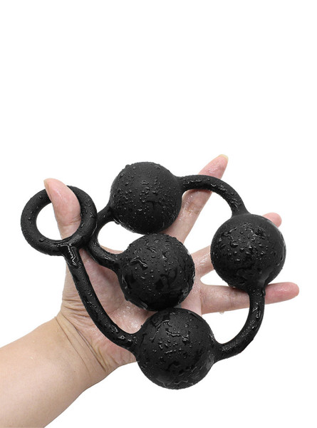 A close-up of the ultra-long silicone anal bead strand in a hand, wet with water droplets, highlighting the smooth silicone texture.