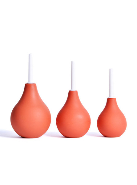 Red anal douche ball with a slim white nozzle, standing upright.