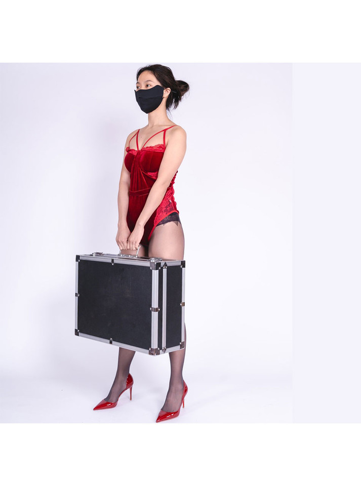 Woman in red velvet lingerie holding the discreet carrying case