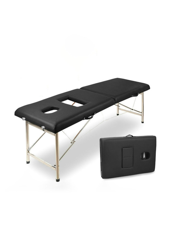 Folded black massage table with chest cut-out and face hole shown closed.