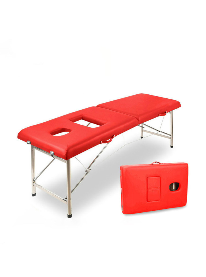 Red foldable erotic massage table with chest and face cut-outs, fully extended.