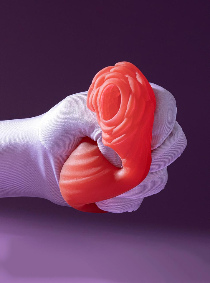 Flexible red rose stroker squeezed in gloved hand