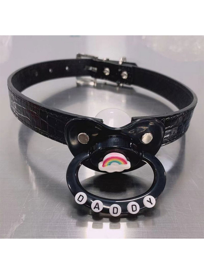 All-black adult pacifier gag with silicone nipple, crocodile-textured adjustable strap, rainbow detail, and "DADDY" letter beads; designed for DDLG, ABDL, and kink play.