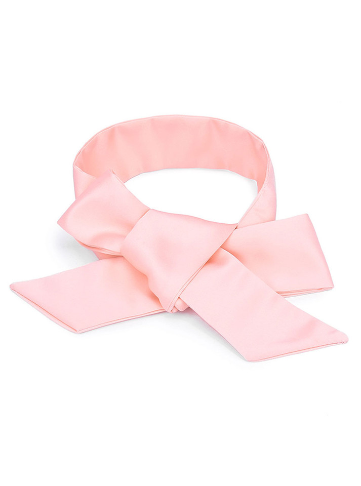 Close-up of untied pink satin ribbon laid flat