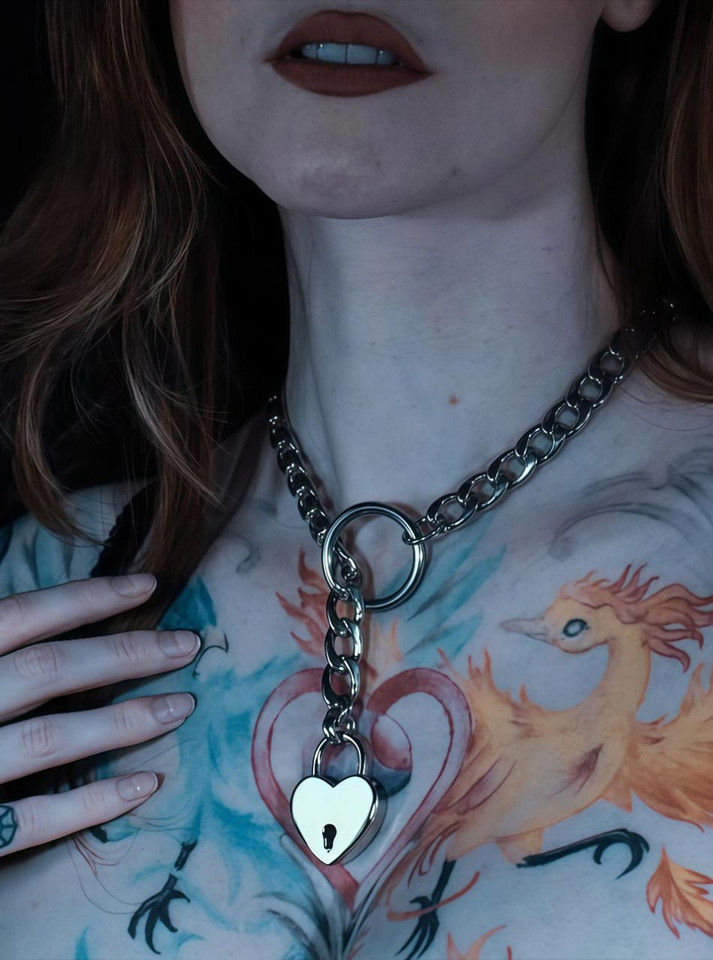 Styled photo of submissive model wearing stainless steel collar