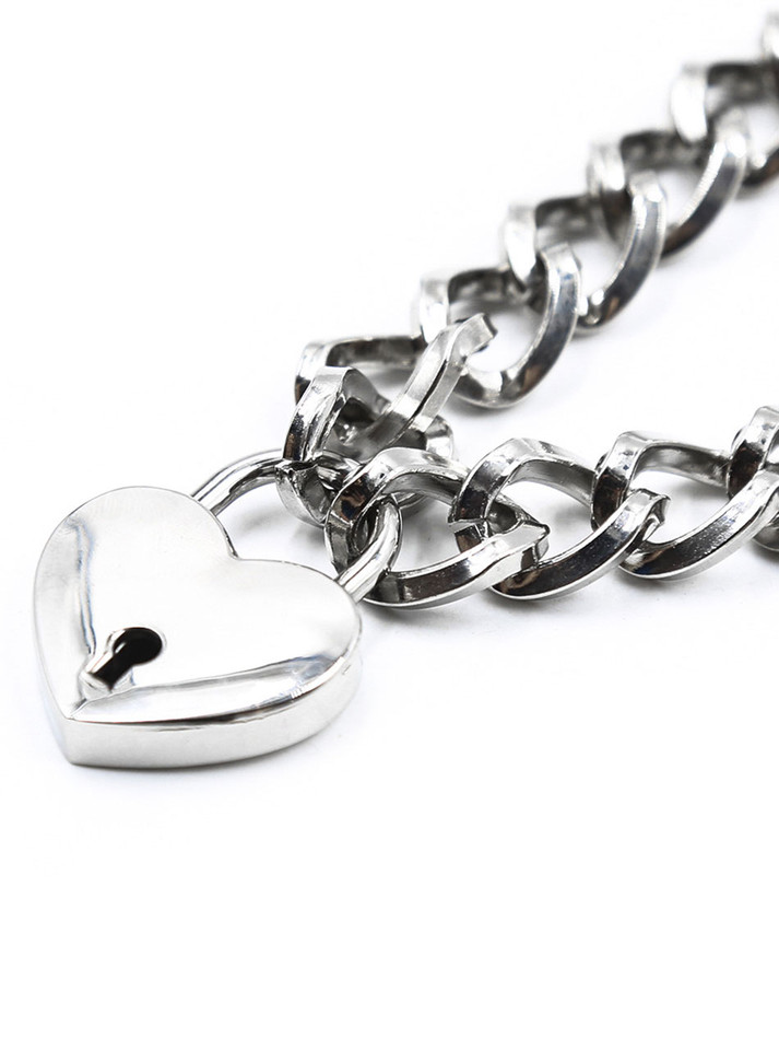 Close-up of silver heart padlock and chain links
