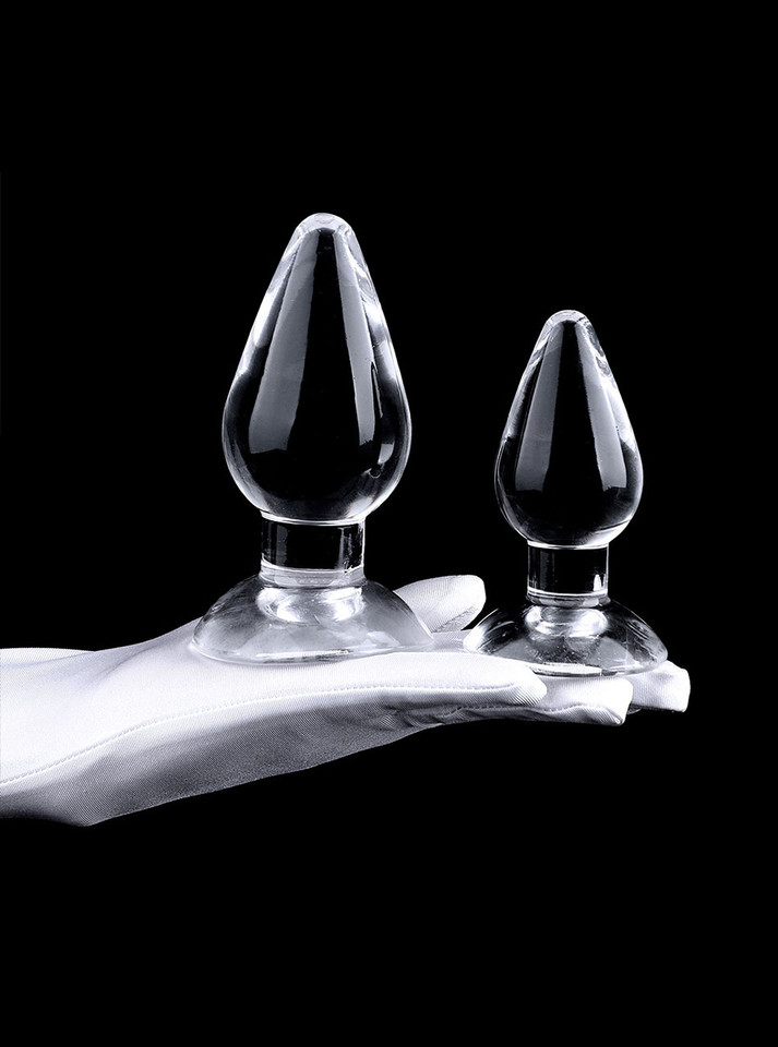 Close-up of three clear teardrop TPE plugs showing glossy finish and flared bases.