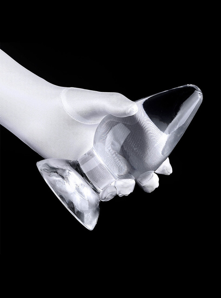 Two clear teardrop TPE plugs resting on a gloved hand for size comparison.