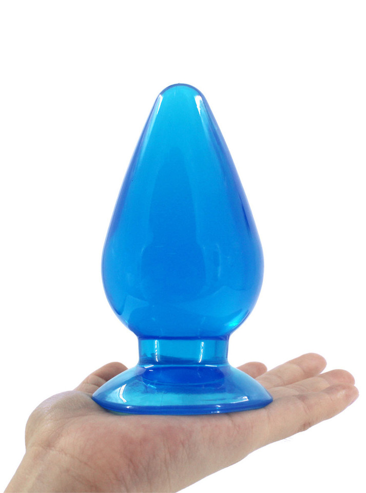 Front view of blue translucent teardrop anal plug resting on an open palm.