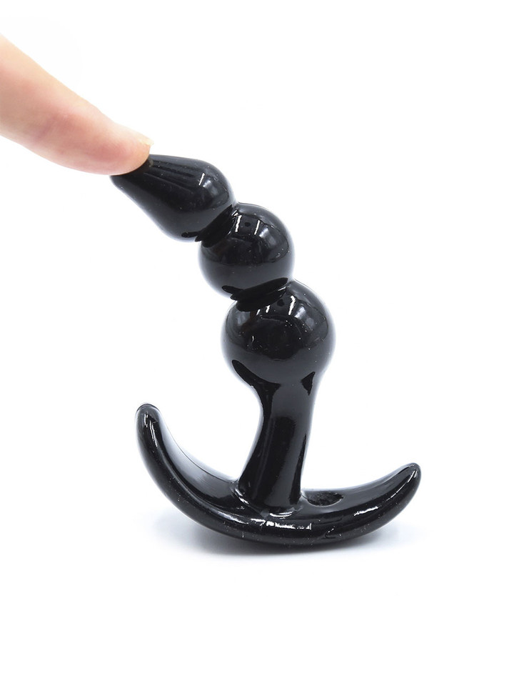 Flexible black beaded anal plug bending demonstration