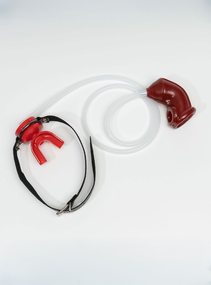 Red mouth gag with red silicone sleeve and clear piss play tube