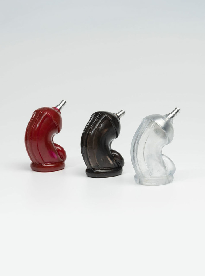 Clear, black, and red silicone sleeve attachments for piss play tube kit