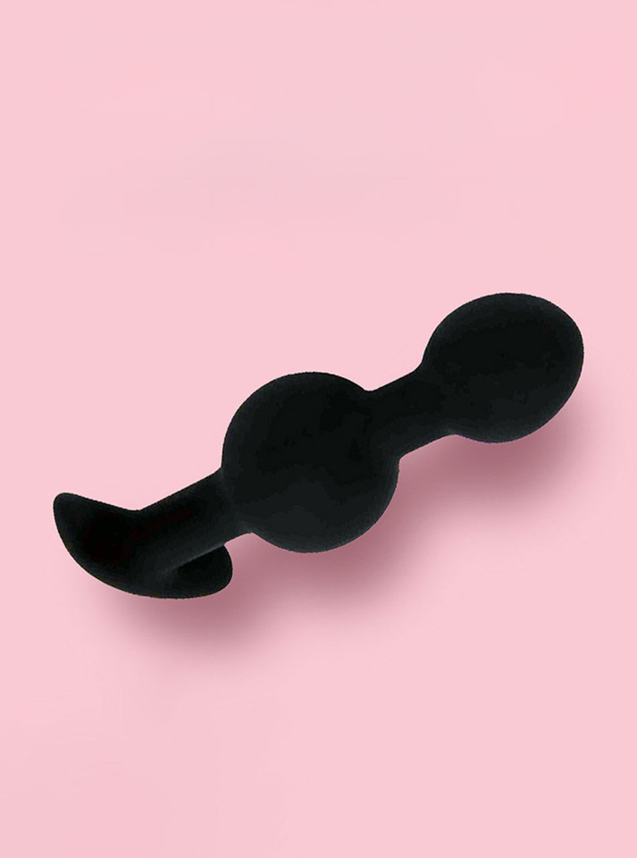 Black silicone double-bulb anal trainer with smooth rounded shape and curved anchor base