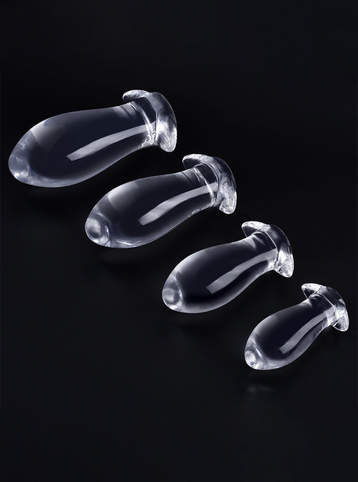 Four clear TPE anal dragon egg butt plugs arranged from XL to Small