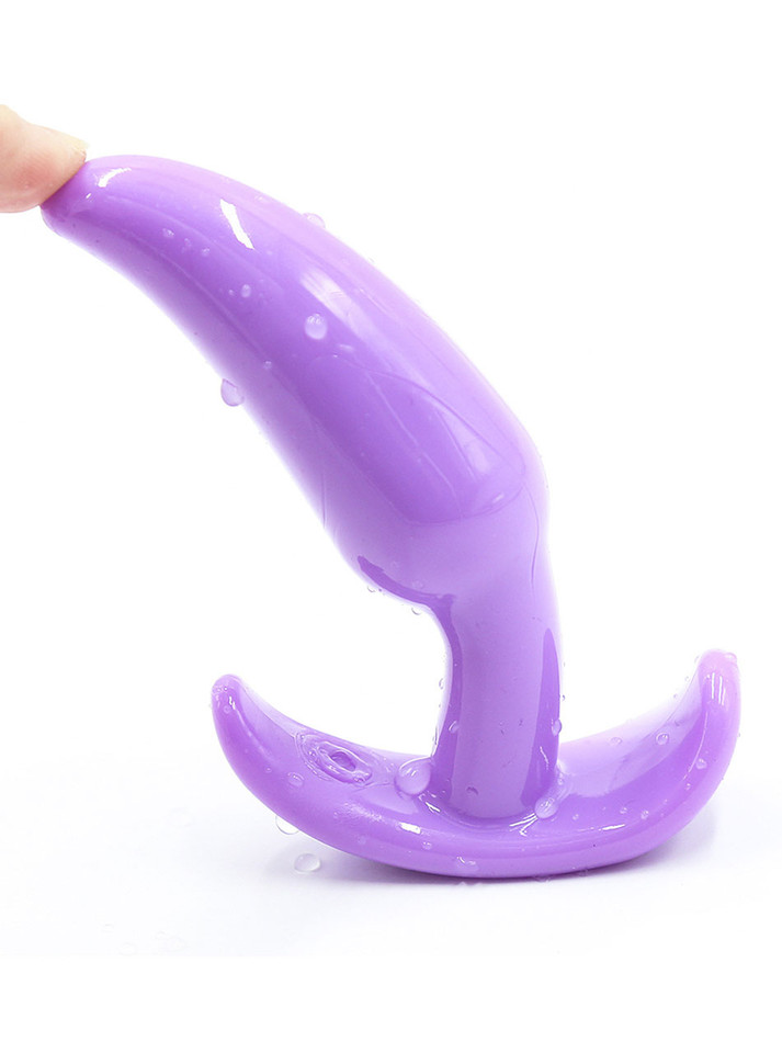 Purple flexible silicone anchor butt plug bent to show its soft construction