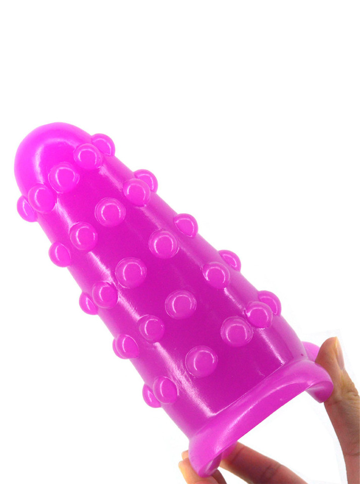 Purple oversized PVC butt plug shown at an angle with rows of raised stimulation nubs