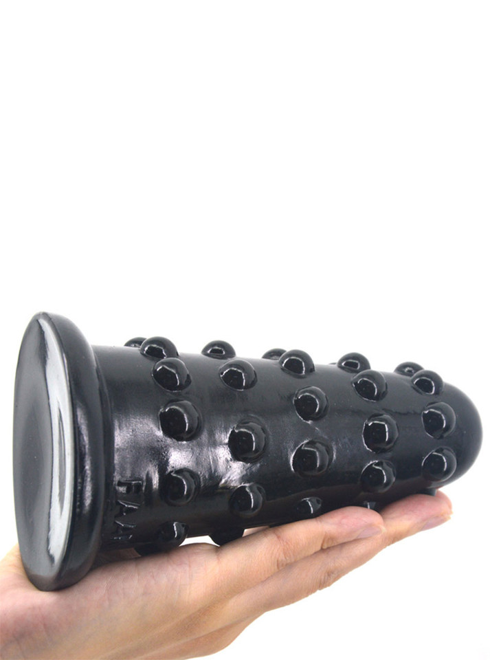 Black XL textured butt plug with 156 mm (6.14 in) total length and 72 mm (2.83 in) largest diameter shown across a hand