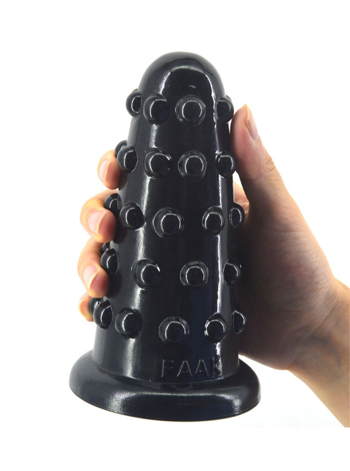 Black XL nubbed PVC butt plug with raised dots and wide flared base shown in hand