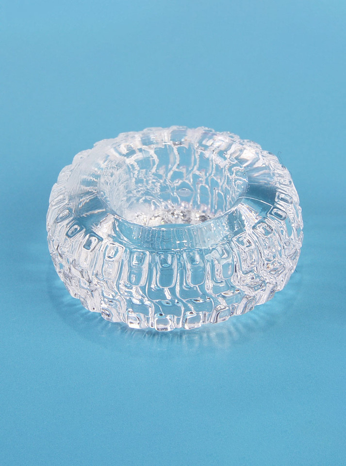 Close-up of transparent TPE Tire Ring cock ring with detailed tyre tread texture.