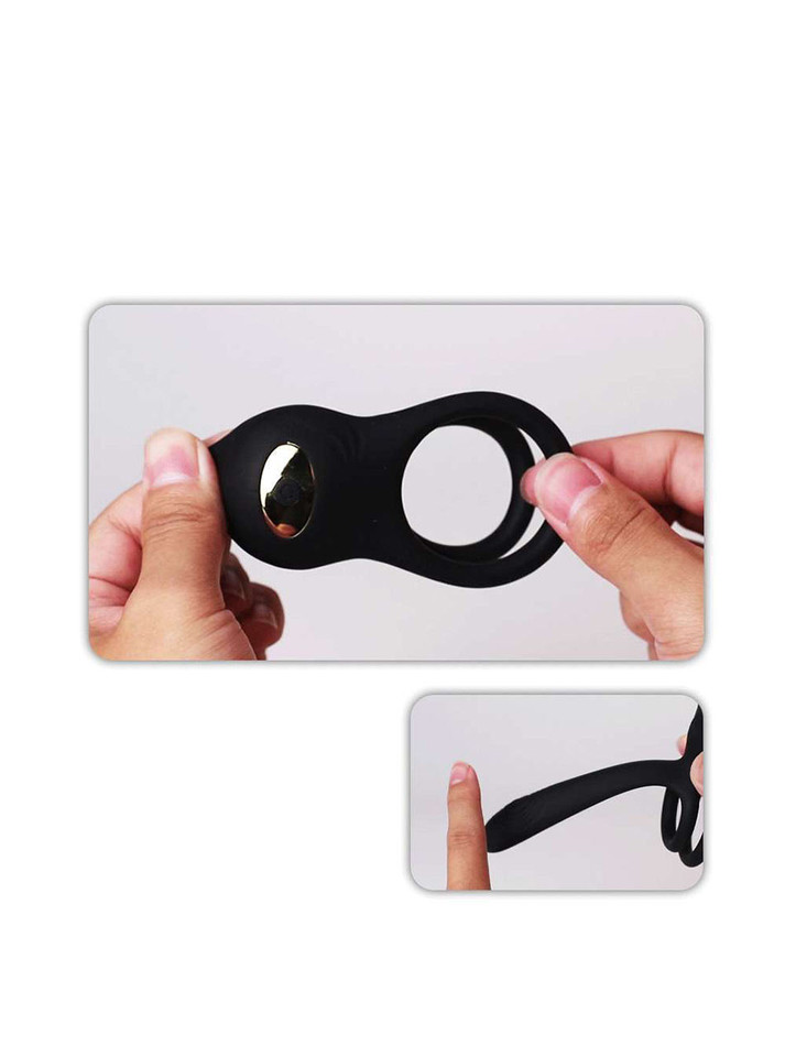 Flexible silicone vibrating cock ring shown stretched by hand with soft elastic body