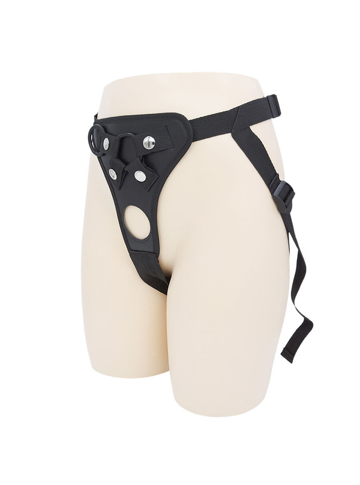 Black faux leather open back strap-on harness worn on mannequin with adjustable waist and thigh straps.