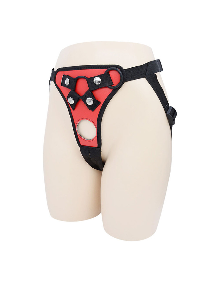 Red faux leather strap-on harness colour option shown on mannequin with adjustable black straps.
