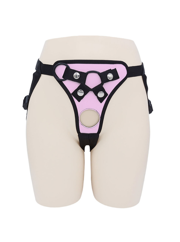 Front view of Pink faux leather strap-on harness with round front opening and metal hardware.