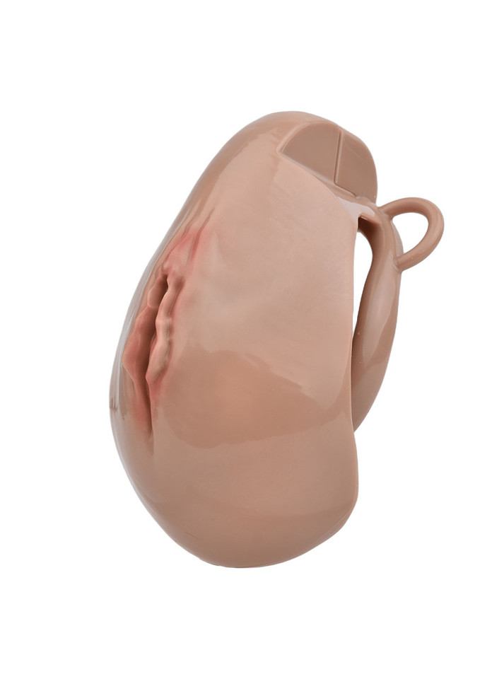 Deep Nude resin vagina chastity cage angled side view showing curved cage shape