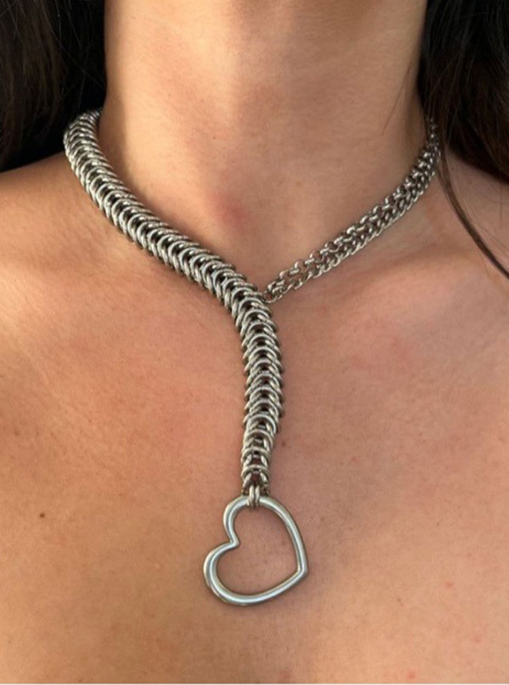 Silver heart lariat chain necklace worn on bare skin