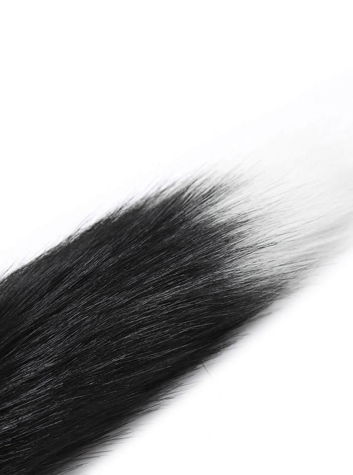 A close-up of the Midnight Whisper's plush tail, highlighting the smooth transition from darkness to light.