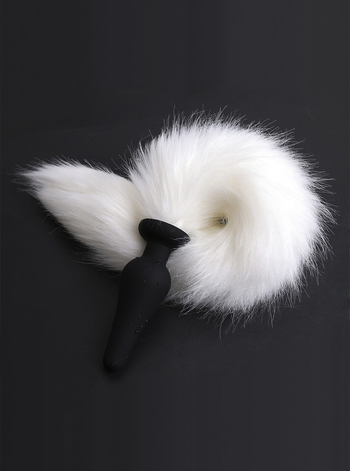 Black and white contrast of the fox tail plug, a symbol of serenity in pet play.