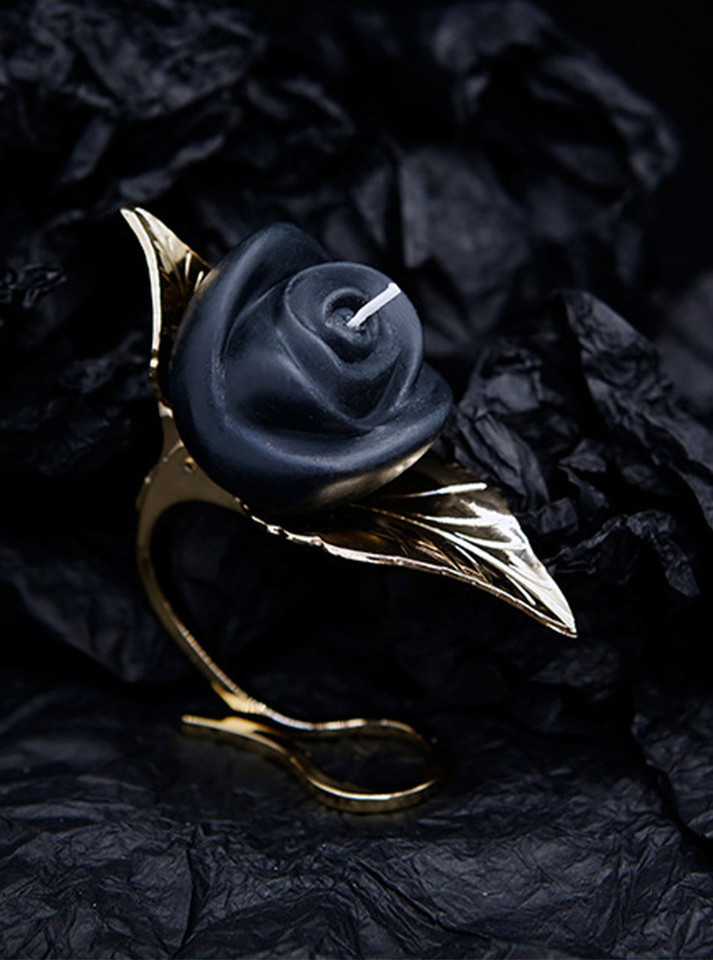 Luxurious gold leaf candle holder with a rose candle, combining classic beauty with sensual warmth.