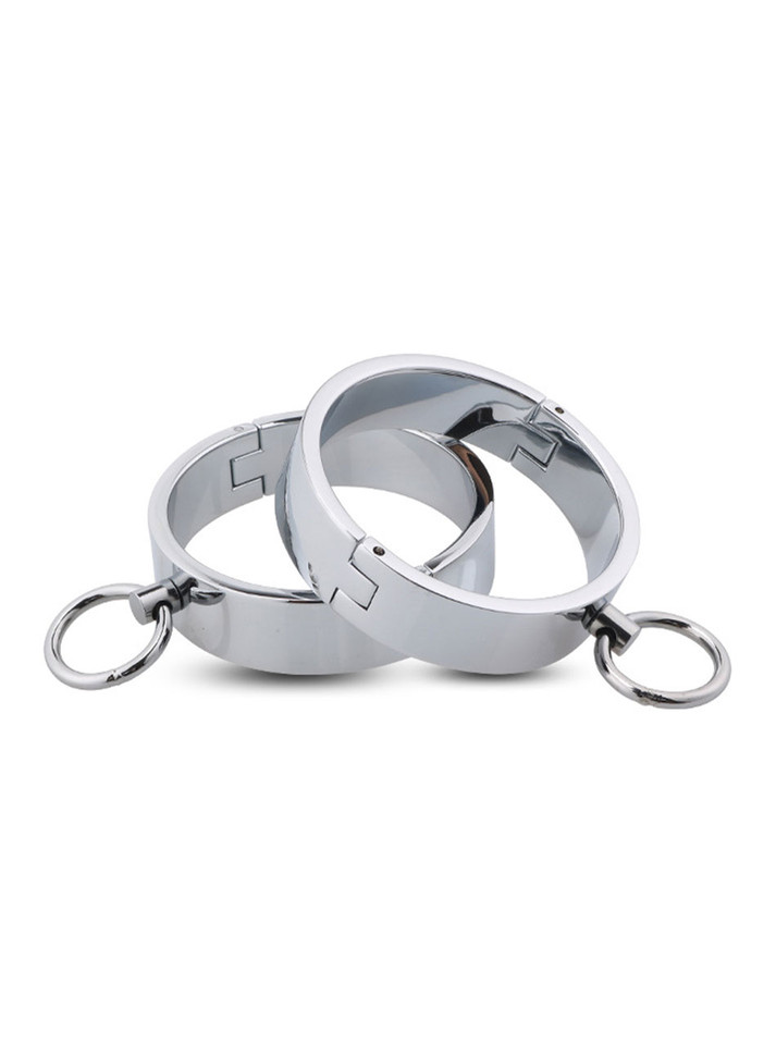 Polished stainless steel wrist cuffs with integrated lock and key, featuring a reflective, sleek design with attached O-rings.