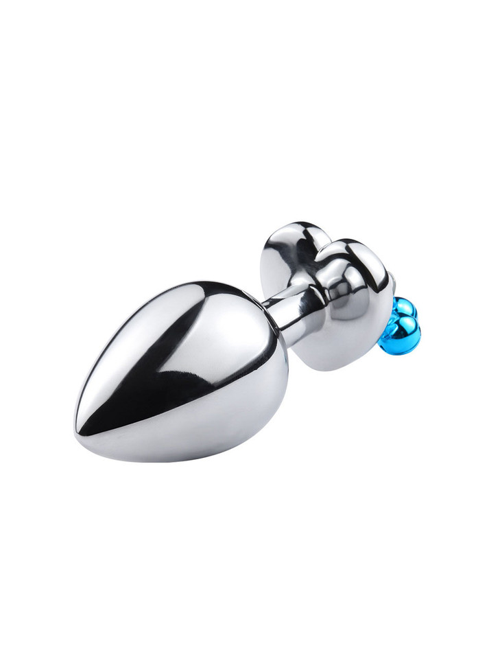 Close-up of red heart jewel on metal butt plug