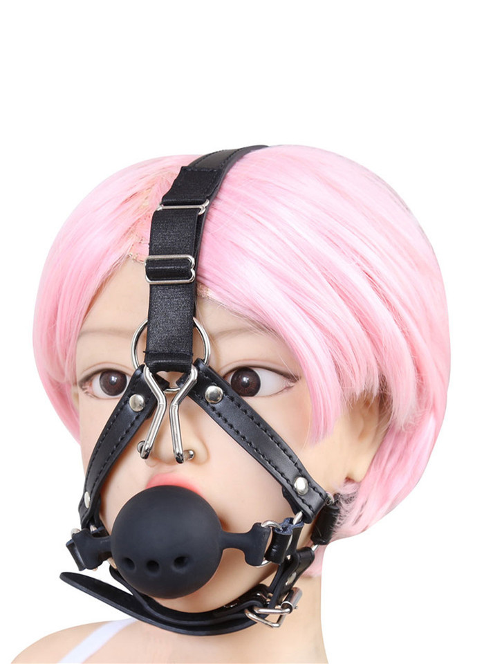 Model wearing the head harness with black silicone ball gag and nose hook
