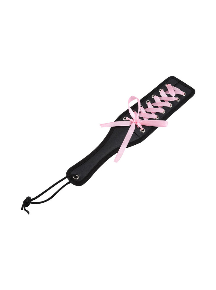 Vegan leather paddle with ergonomic handle and pink ribbon lacing, designed for strong impact and enhanced psychological effect.