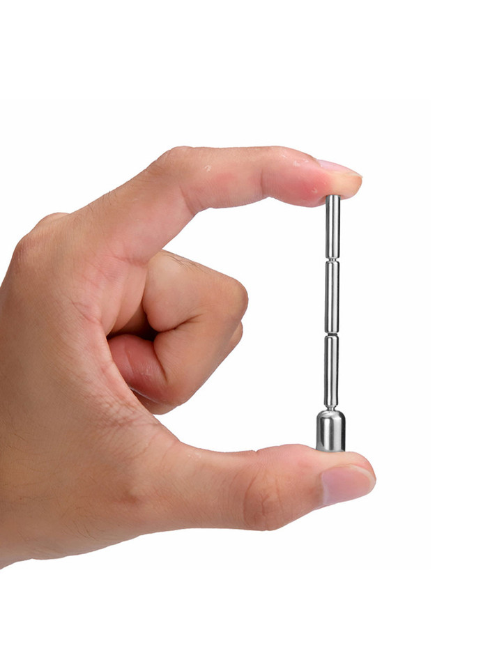 Hand holding Pleasure Penis Plug with Blue Gemstone for size reference.