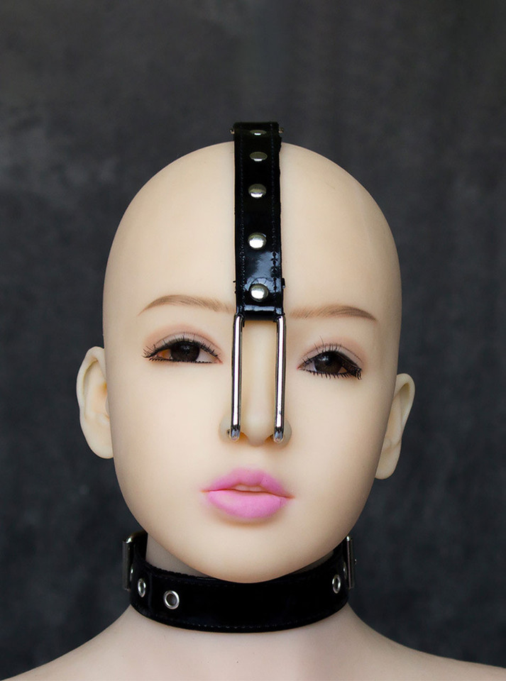 The Leather and Metal Nose Hook Restraint worn on a mannequin head, demonstrating the nose hook in use.