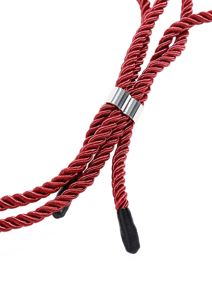 Close-up of red bondage rope collar with metal clasp