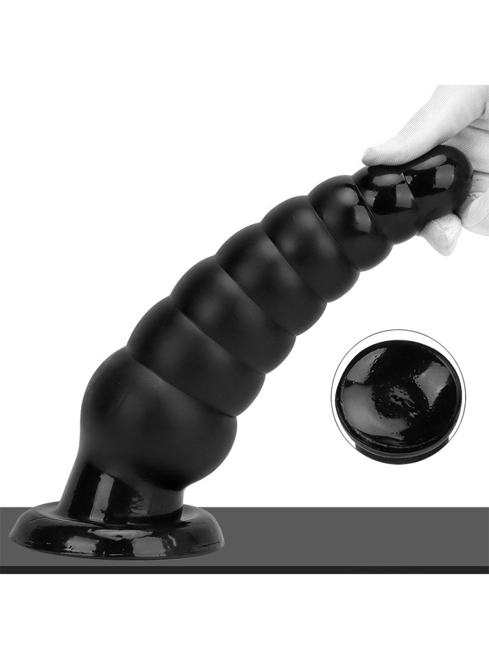 Monster-sized PVC anal plug with suction base for hands-free play.