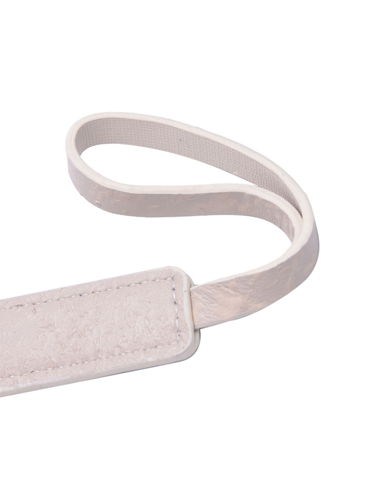 Close-up of the hand-distressed beige leather texture on the paddle.