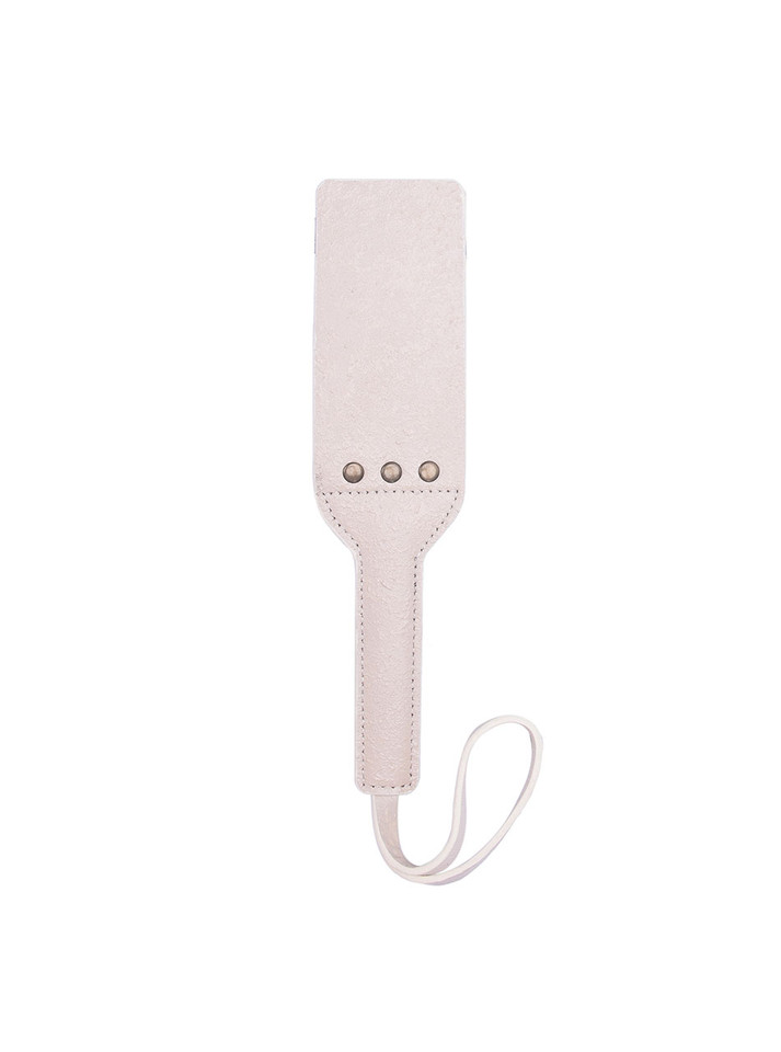 Beige leather BDSM paddle placed flat, highlighting its sleek and durable design.