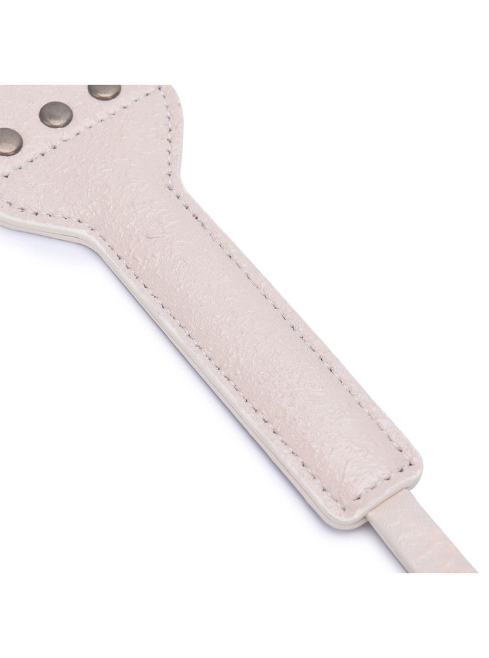 Close-up of the hand-distressed beige leather texture on the paddle.