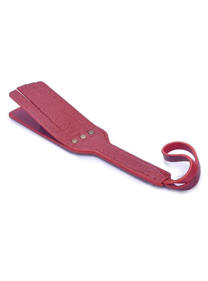 Full view of the red real leather double-layer paddle with a textured finish.