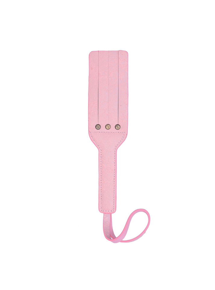 Pink leather paddle laid flat, showcasing its pastel color and premium material.